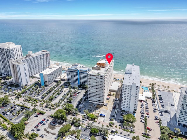 drone / aerial view featuring a water view and a beach view