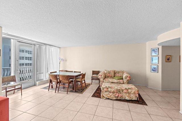 tiled living room featuring a textured ceiling