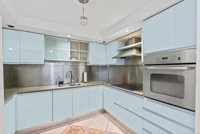 kitchen with light tile patterned floors, oven, sink, black electric cooktop, and decorative backsplash