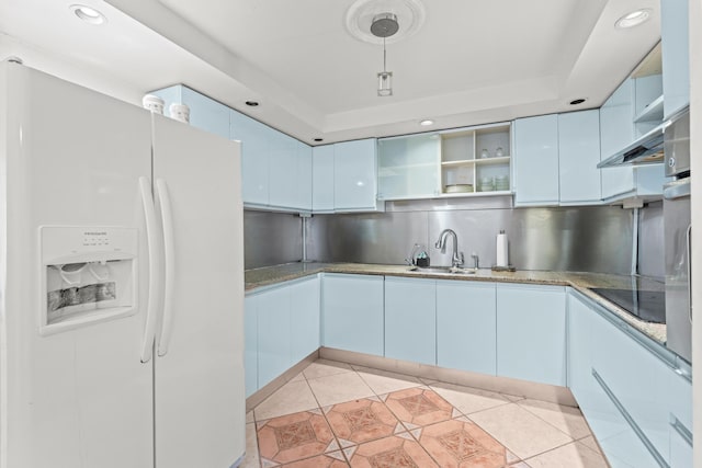 kitchen featuring tasteful backsplash, sink, white fridge with ice dispenser, black electric stovetop, and light tile patterned flooring