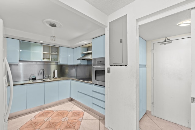 kitchen with backsplash, light tile patterned floors, electric panel, stainless steel oven, and blue cabinets