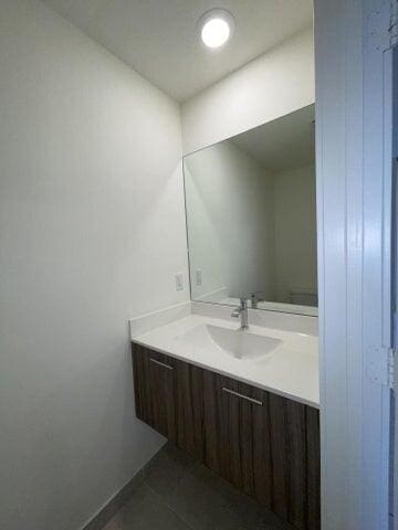 bathroom featuring tile patterned flooring, vanity, and toilet