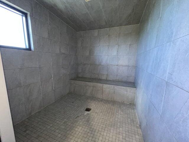 bathroom with a tile shower