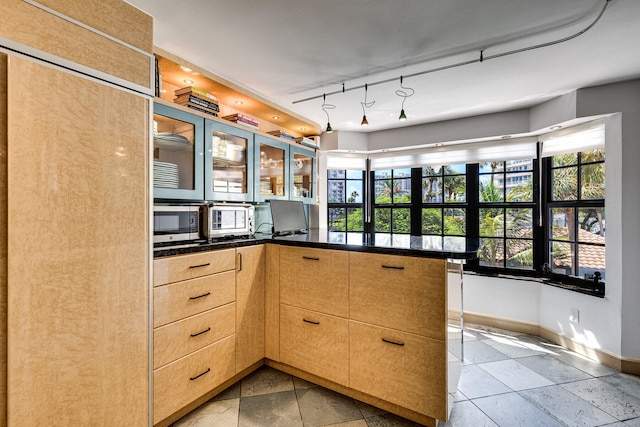 kitchen featuring rail lighting, light brown cabinets, and kitchen peninsula