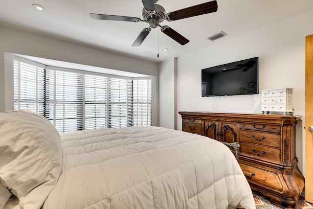 bedroom with multiple windows and ceiling fan