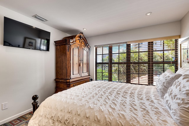 bedroom with multiple windows