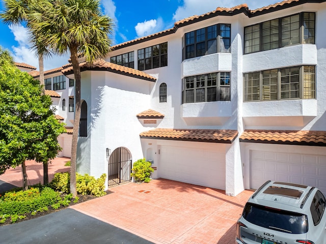 mediterranean / spanish-style house with a garage