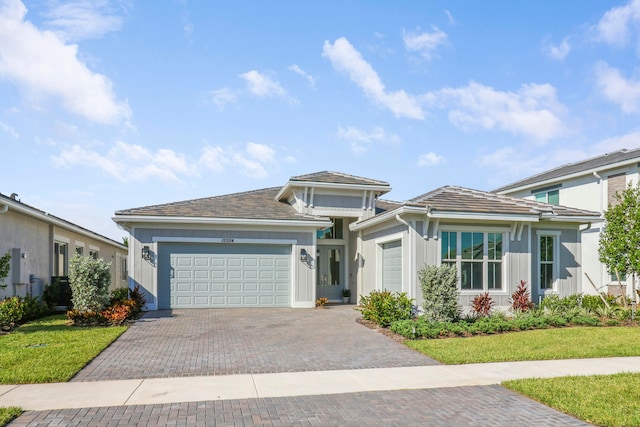 view of front facade with a front yard and a garage