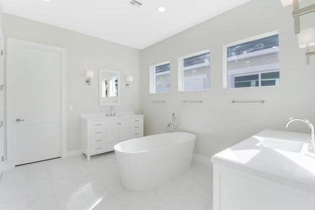 bathroom with vanity and a bathtub