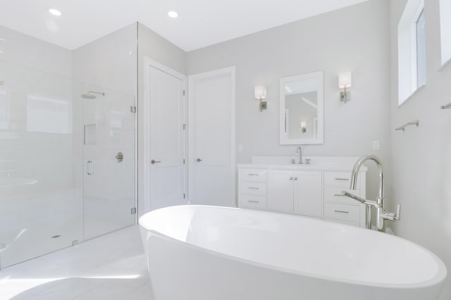 bathroom featuring vanity and shower with separate bathtub