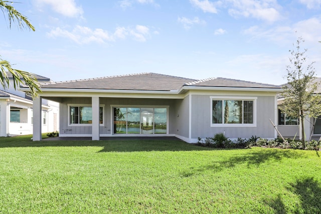 rear view of house with a yard