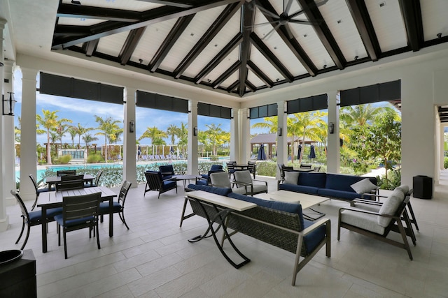 sunroom with plenty of natural light and vaulted ceiling with beams