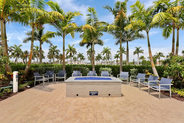 view of home's community with a fire pit and a patio area