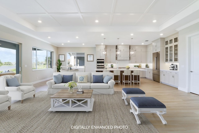 living room with crown molding and light hardwood / wood-style flooring