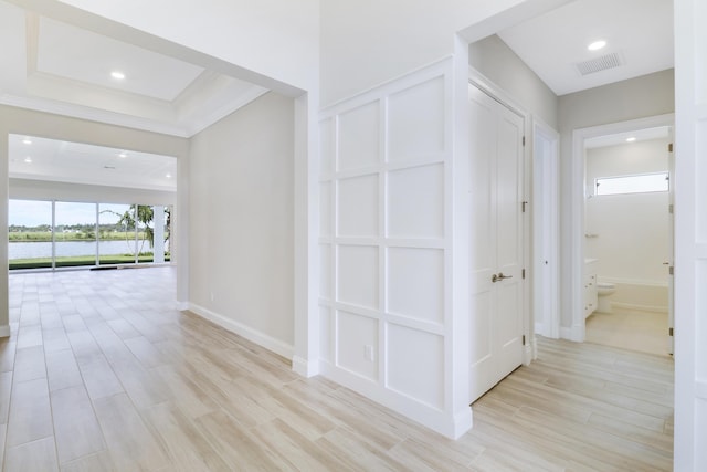 corridor with a wealth of natural light and light wood-type flooring