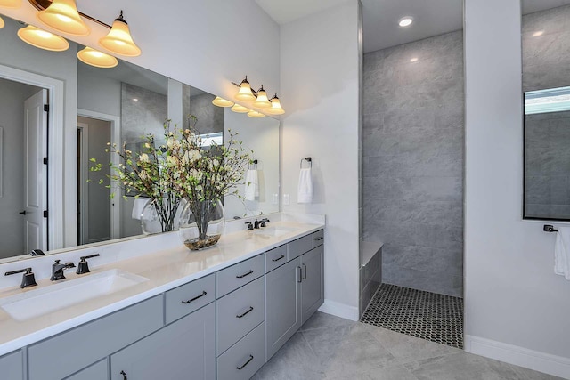 bathroom with vanity and tiled shower