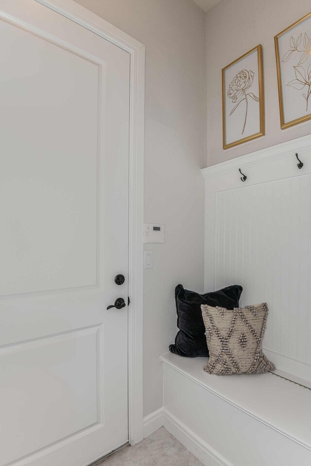 bedroom with a walk in closet, light colored carpet, and a closet