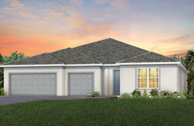 single story home with an attached garage, a front lawn, decorative driveway, and stucco siding