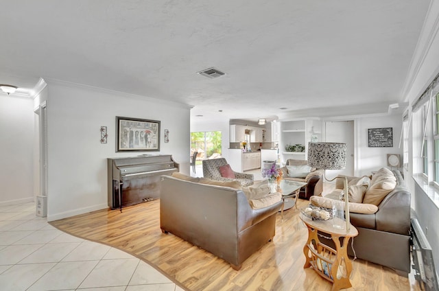 living room with crown molding and light hardwood / wood-style flooring