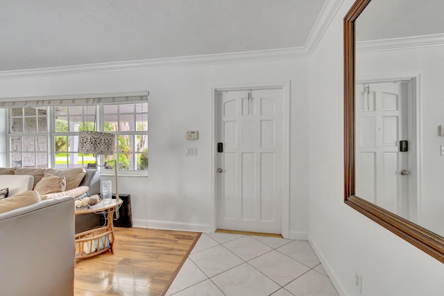 foyer with crown molding and light hardwood / wood-style flooring