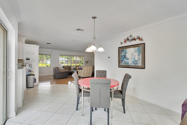 tiled dining space featuring crown molding and a notable chandelier