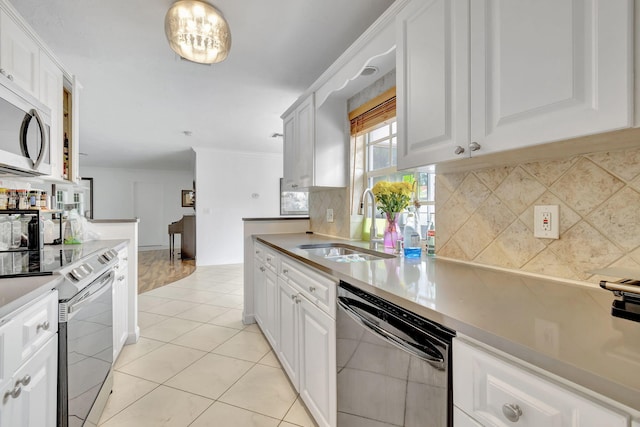 kitchen featuring light tile patterned floors, appliances with stainless steel finishes, sink, decorative backsplash, and white cabinets