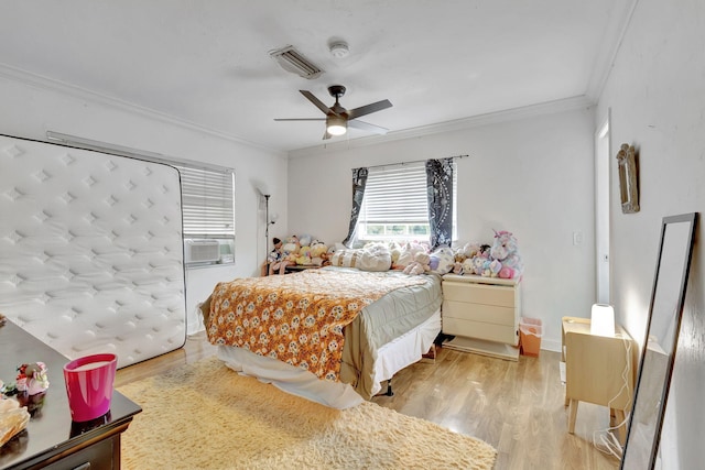 bedroom with crown molding, hardwood / wood-style floors, cooling unit, and ceiling fan