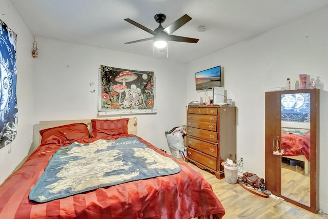 bedroom with light hardwood / wood-style flooring and ceiling fan