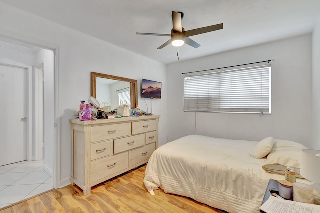 bedroom with ceiling fan and light hardwood / wood-style flooring