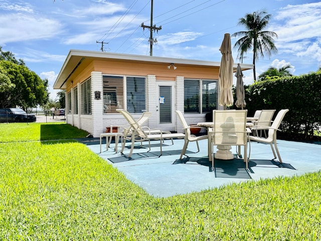 back of property featuring a yard and a patio