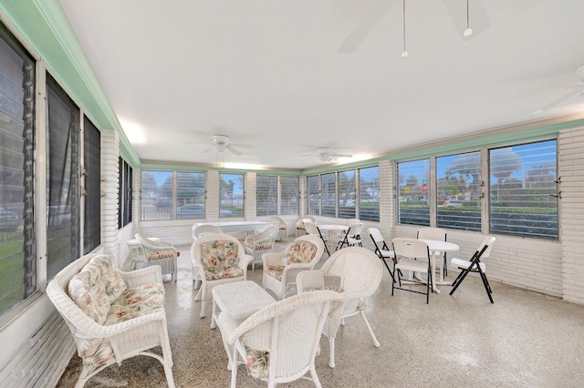 sunroom featuring ceiling fan