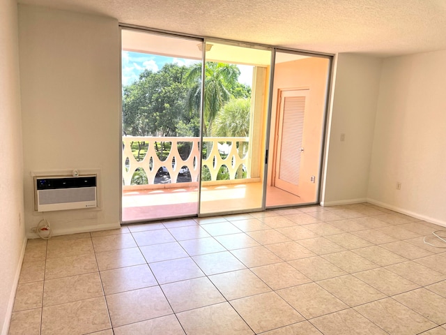 tiled empty room with a textured ceiling