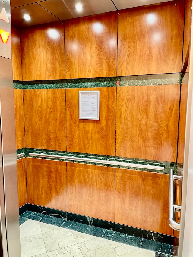 interior space featuring tile patterned flooring and elevator