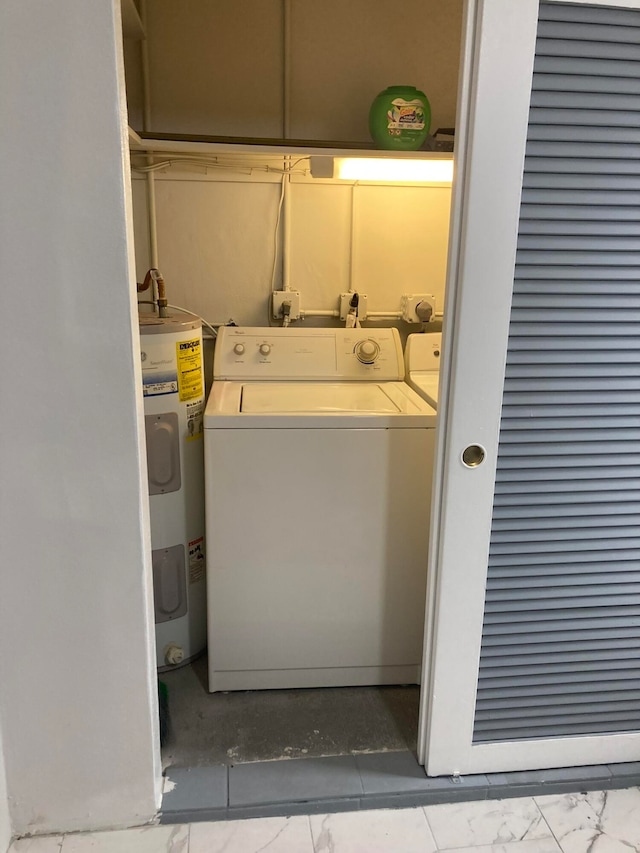 laundry area featuring electric water heater and washer / clothes dryer