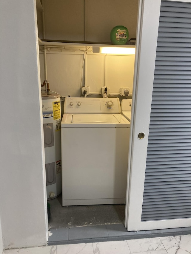 108 NE 20th Ave Unit 205, Boynton Beach, FL 33435 - laundry area featuring washer / dryer, water heater, and marble finish floors