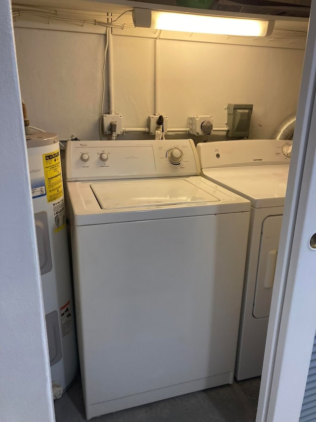 washroom with electric water heater and washing machine and dryer