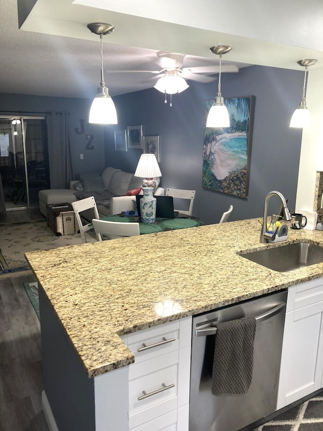 108 NE 20th Ave Unit 205, Boynton Beach, FL 33435 - kitchen with stainless steel dishwasher, a sink, white cabinetry, dark wood-type flooring, and light stone countertops
