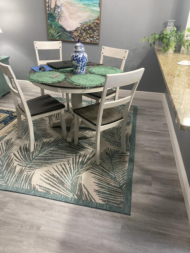 108 NE 20th Ave Unit 205, Boynton Beach, FL 33435 - dining room with baseboards and wood finished floors