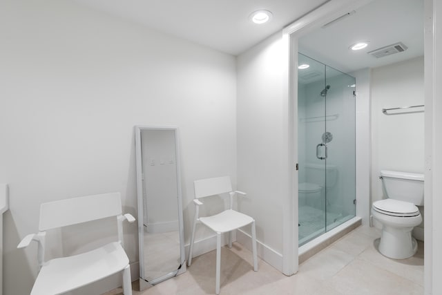 bathroom featuring tile patterned floors, walk in shower, and toilet