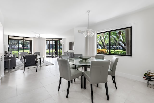 dining room featuring light tile patterned flooring and ceiling fan with notable chandelier