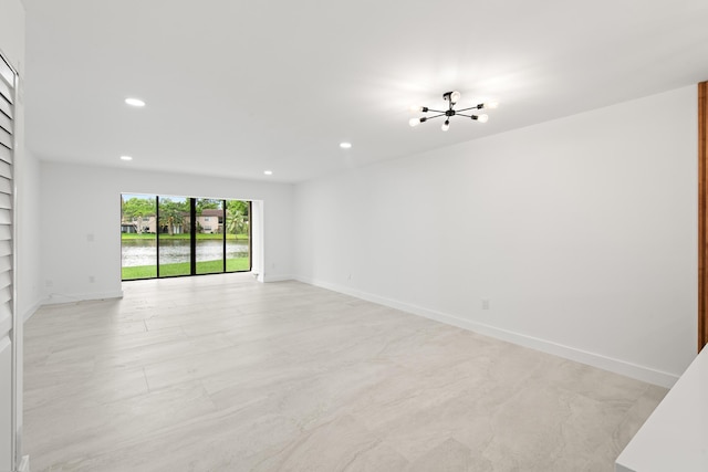 spare room featuring recessed lighting, built in shelves, and baseboards