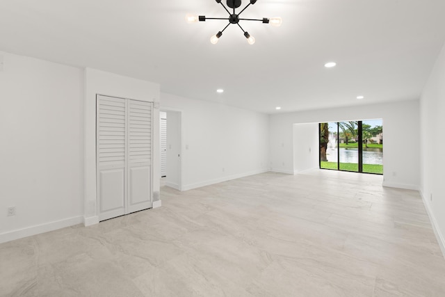 unfurnished room with recessed lighting and baseboards