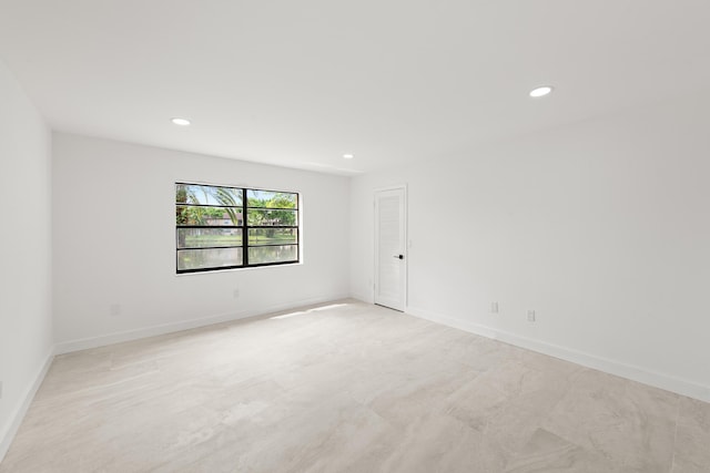 empty room with recessed lighting and baseboards