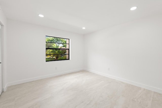 empty room with recessed lighting and baseboards