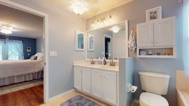 bathroom featuring hardwood / wood-style floors, ceiling fan, toilet, and vanity