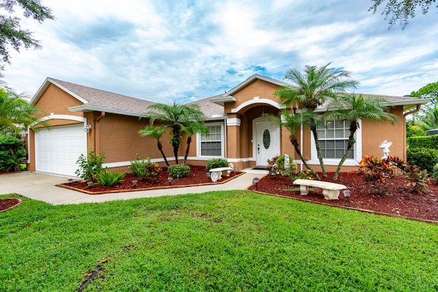 ranch-style home featuring a front yard and a garage