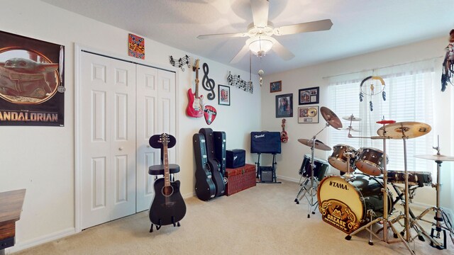 miscellaneous room featuring light carpet and ceiling fan