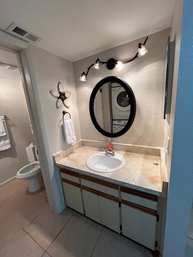 bathroom with tile patterned floors, vanity, visible vents, and toilet