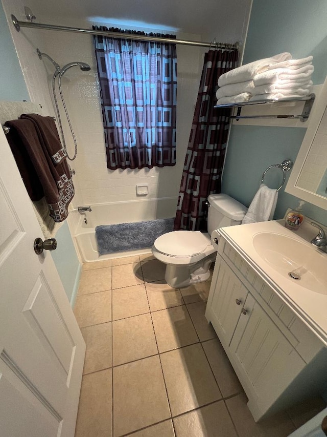 full bathroom with tile patterned flooring, shower / bathtub combination with curtain, vanity, and toilet
