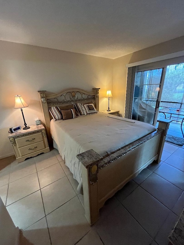 bedroom with access to outside and light tile patterned floors